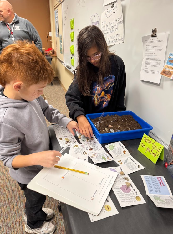 students working hands on with dirt