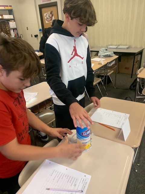 students measuring clorox wipe conatiner
