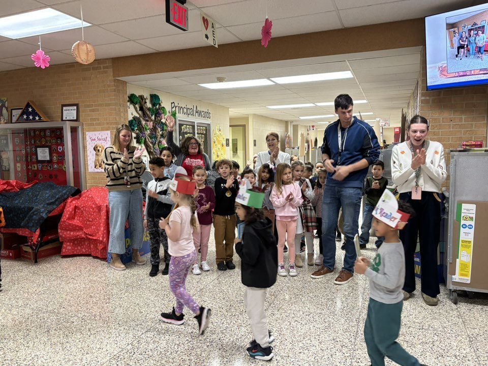 teachers and students cheering for students