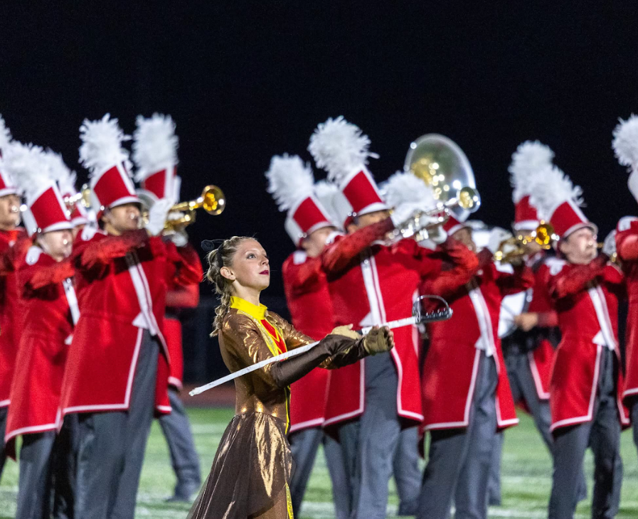 baton twirler with band in background