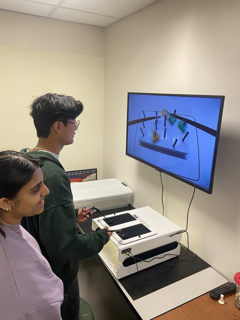students looking at electronics