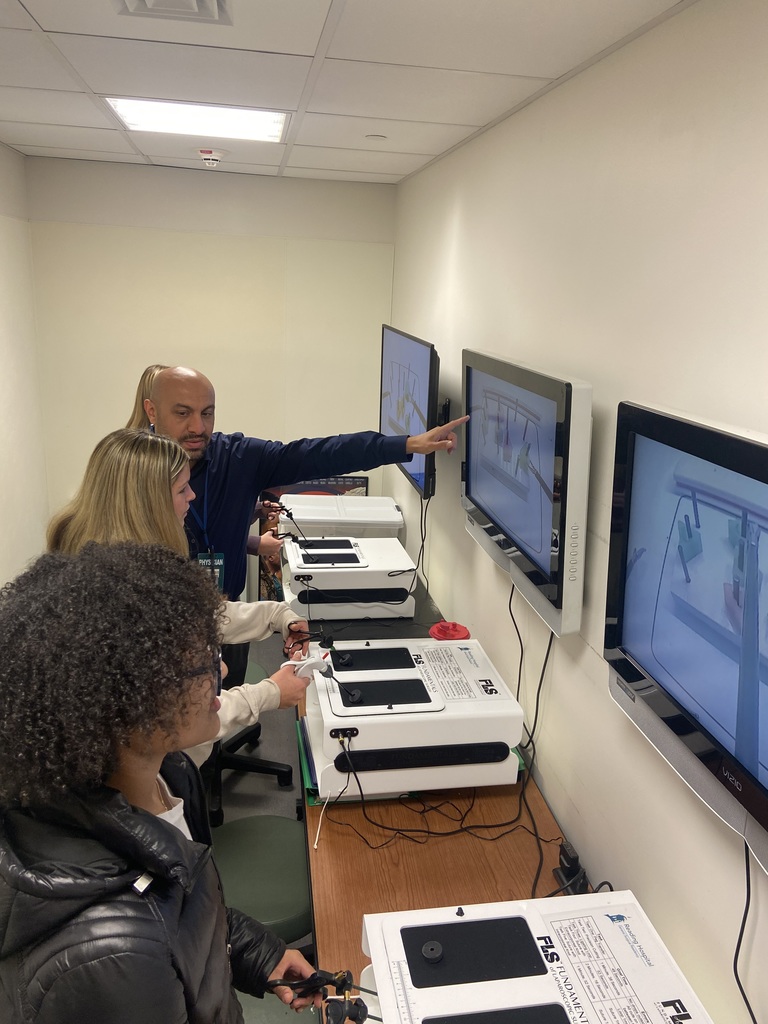 students practicing robotic "surgery"