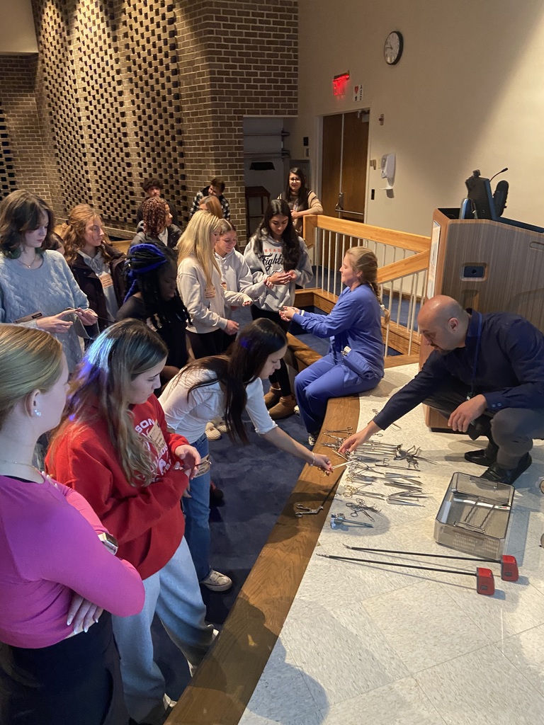 students looking at medical instruments