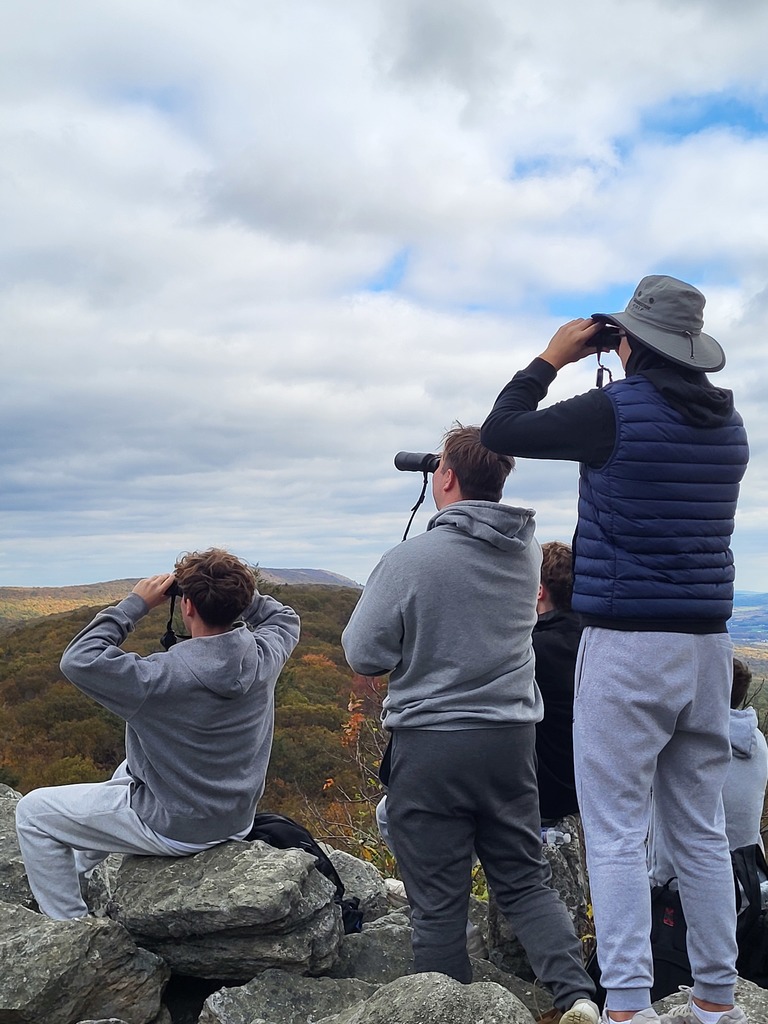 students using binoculars