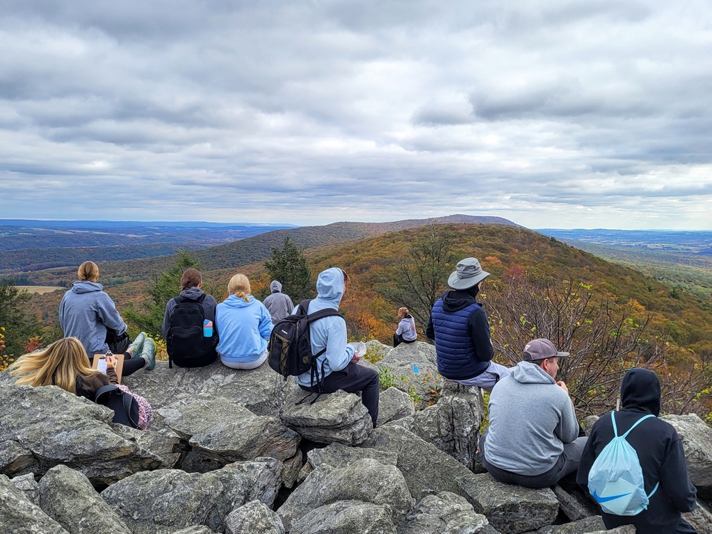 students looking at view from hike