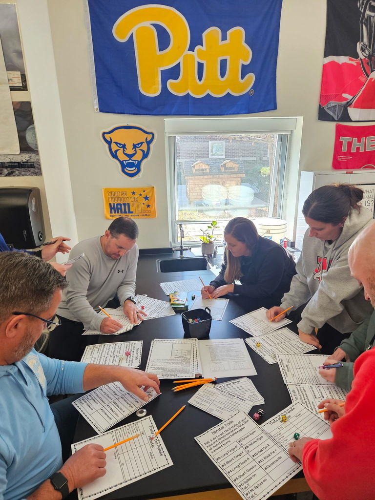 Teachers working together on worksheet