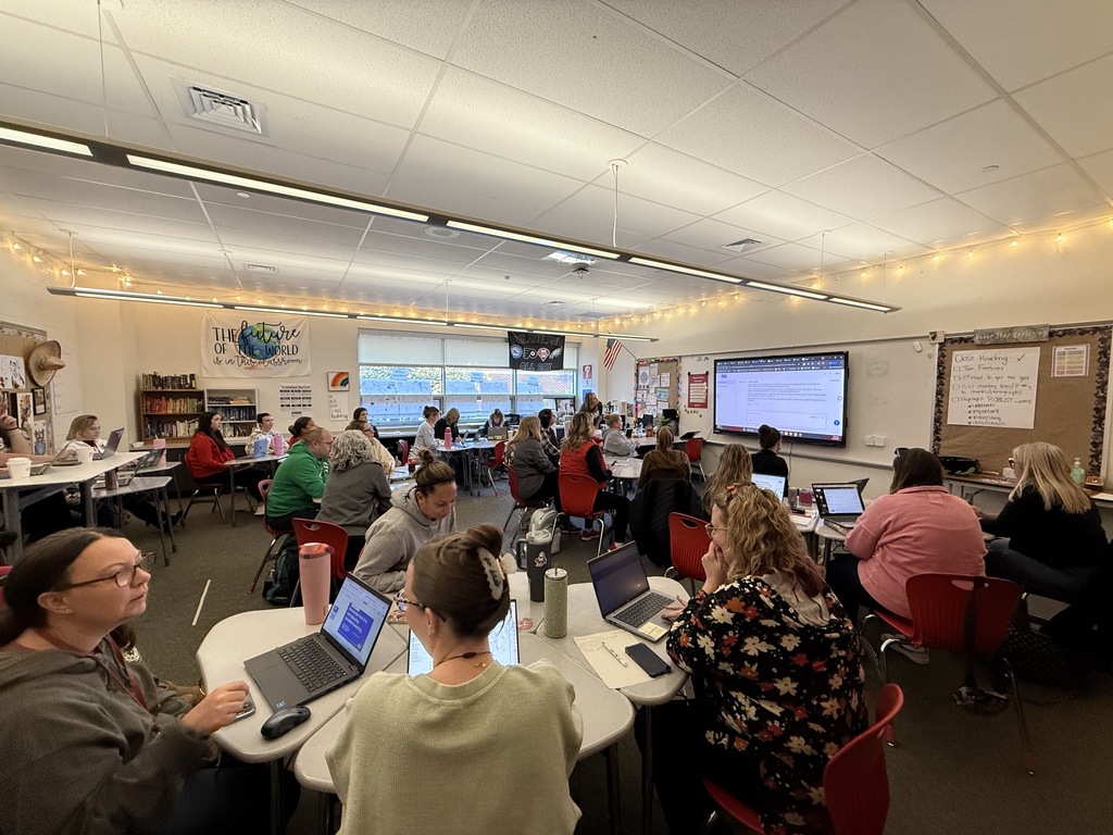 teachers at round tables looking at front