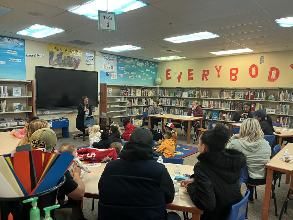 teachers and parents and students  in library