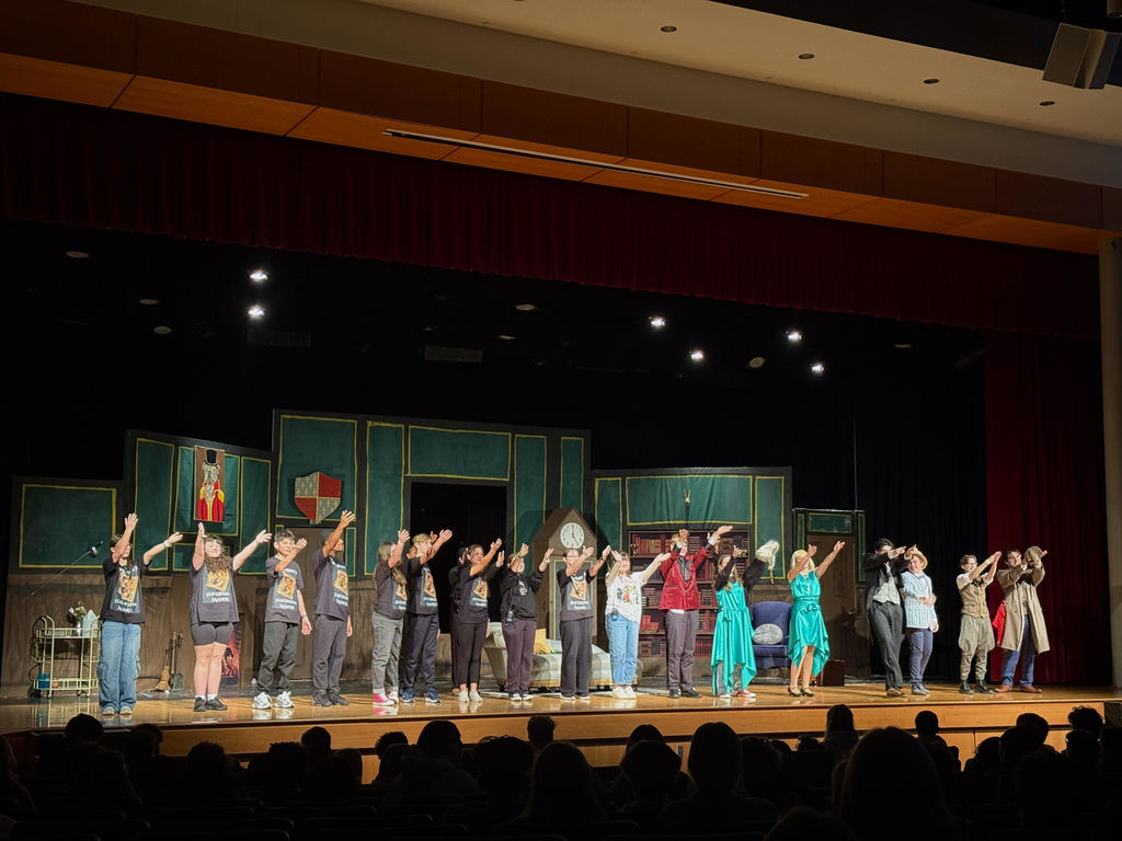 students bowing on stage