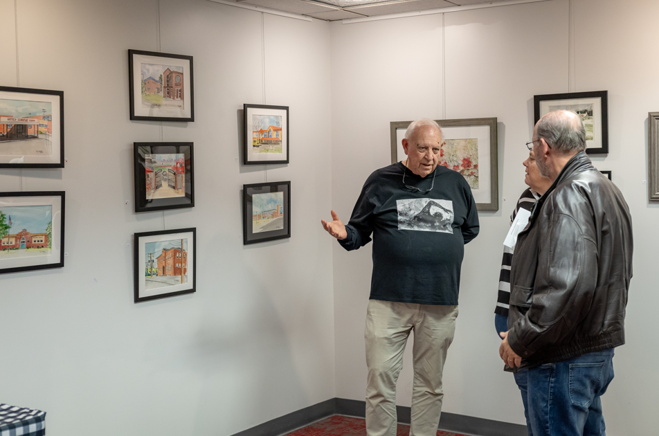 roy talking with people about artwork