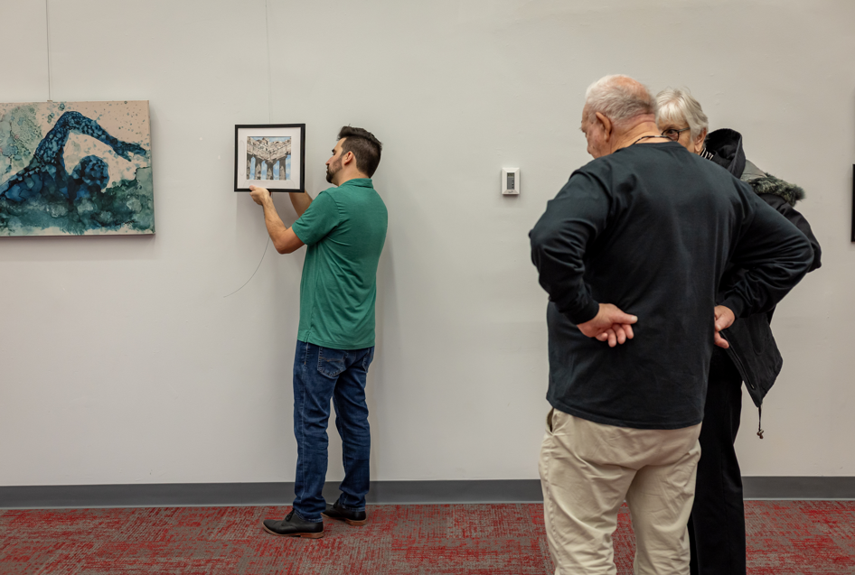 someone hanging artwork