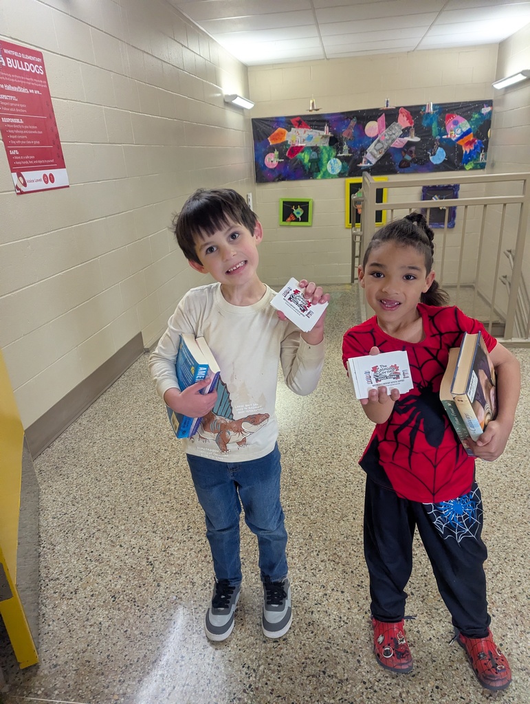 students holding books