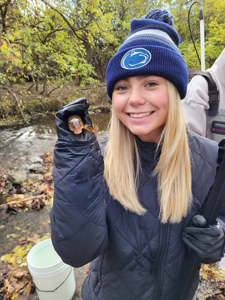 girl holding fish she caught in water