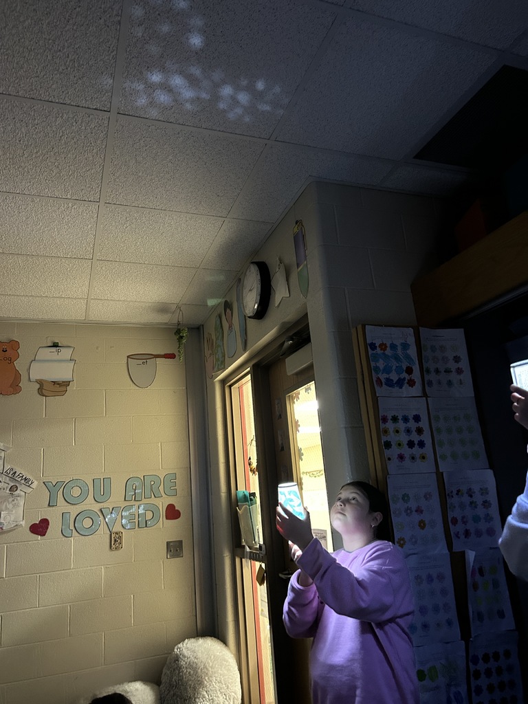 student using cup to make constellation