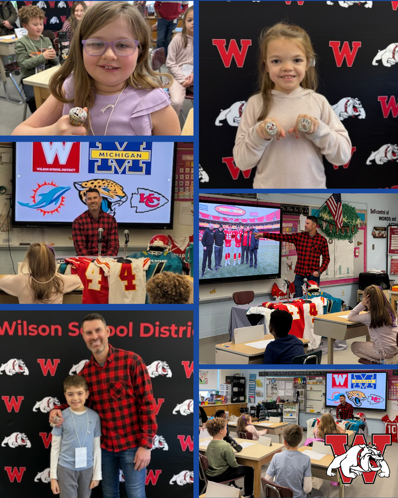 A collage of classroom photos featuring an elementary school visit from a guest speaker. In the top-left image, a young girl with glasses smiles while holding a championship-style ring. In the top-right, another girl stands in front of a backdrop with the Wilson School District “W” and bulldog logo, holding two large rings. In the center-left, the guest speaker—an adult man in a red flannel shirt—stands in front of a screen displaying logos for Wilson School District, the University of Michigan, and several NFL teams, with students seated and watching. In another classroom photo, he points to a projected image of football players while football jerseys and helmets are displayed on a table. In the bottom-left, the guest speaker poses with a smiling student in front of the Wilson backdrop. Additional images show students seated at desks, attentively listening, with the classroom decorated with posters, flags, and learning materials. A Wilson bulldog mascot logo appears in the bottom-right corner of the collage.