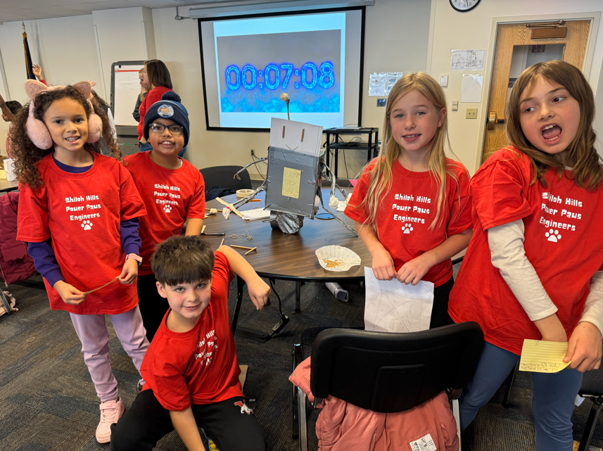 students smiling for picture in red shirt