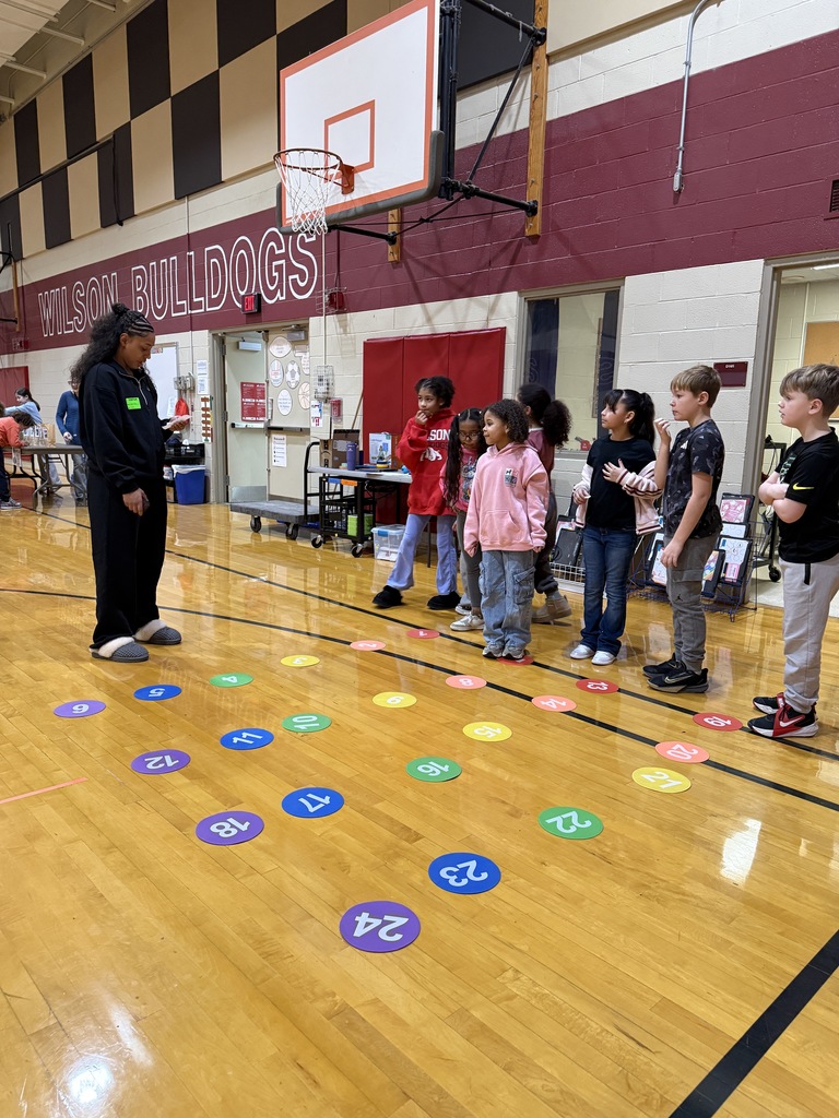 students stepping on numbers on gym floor