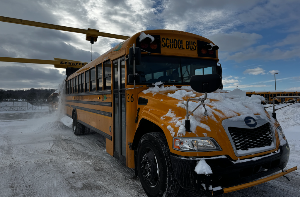school bus going through snow scraper