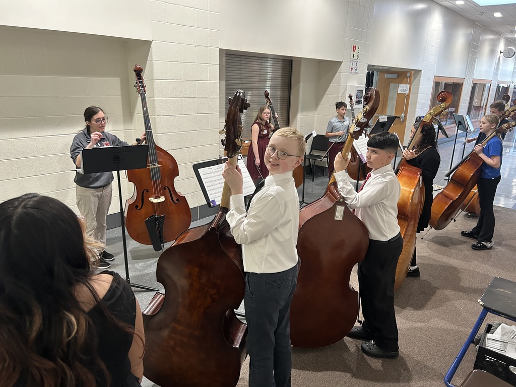 cello students practicing in hallway