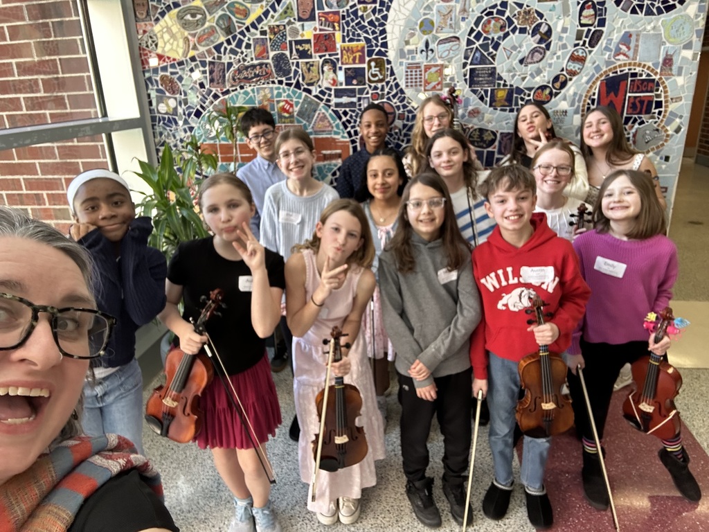 teacher with students and instruments posing for selfie