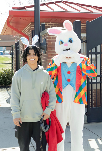 student posing and smiling with easter bunny