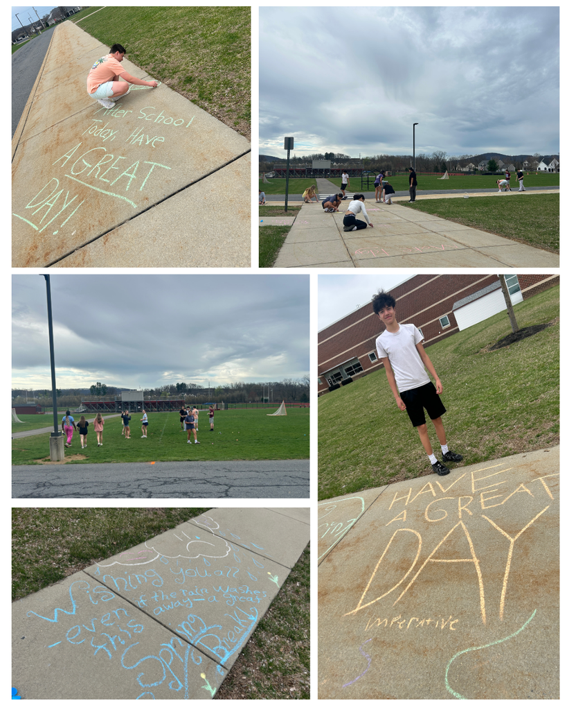 students writing on sidewalk with chalk