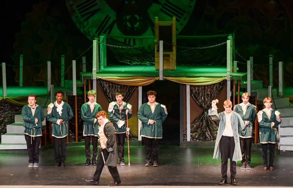 male characters on stage with green lighting