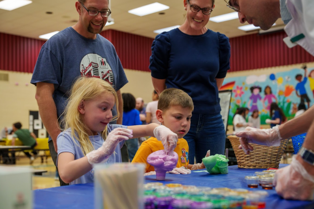 students making what looks like slime with gloves on