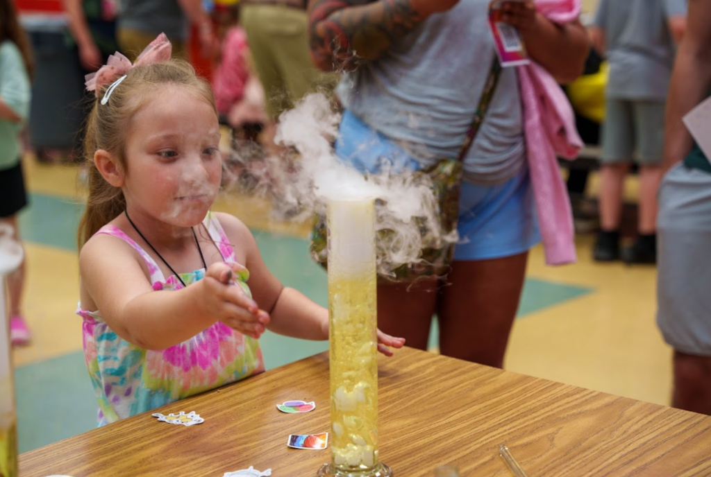student with science experiment with fog
