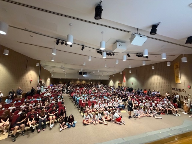 large crowd of parents and students in an auditorium