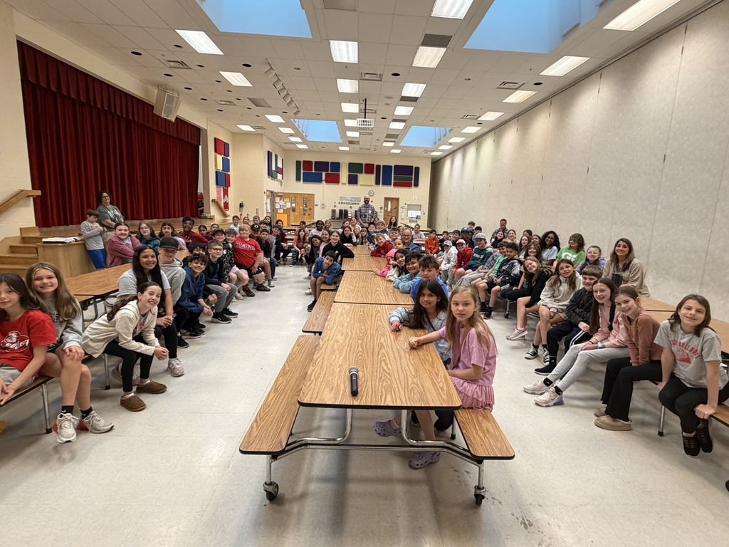students smiling looking at camera in cafeteria