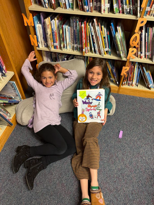 students with book they created