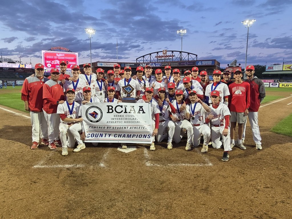 boys baseball team with champions banner