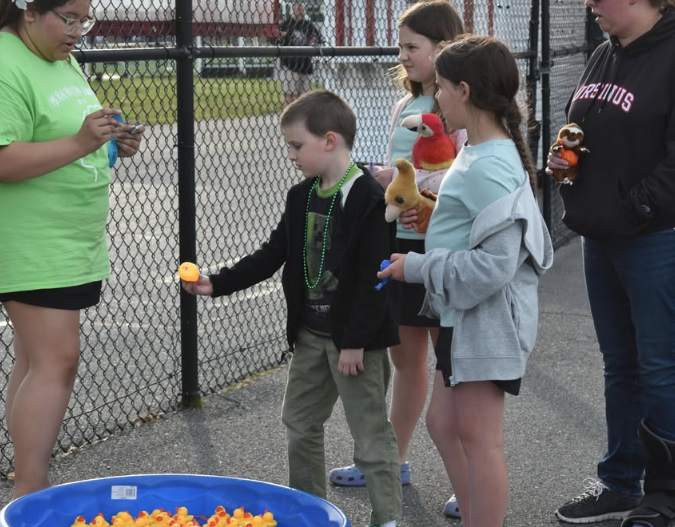 kids picking rubber ducks out of the pool