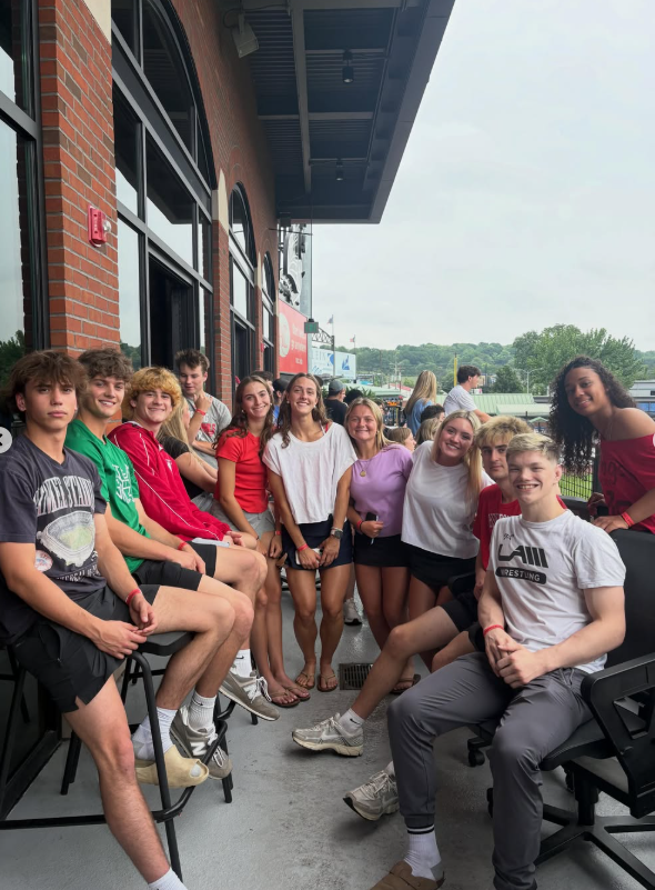 large group of students sitting outside