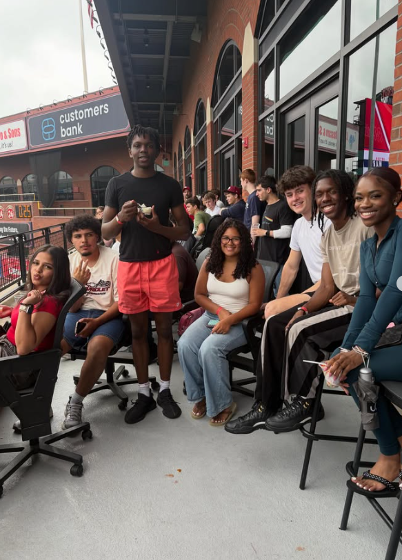 students standing and sitting smiling for picture
