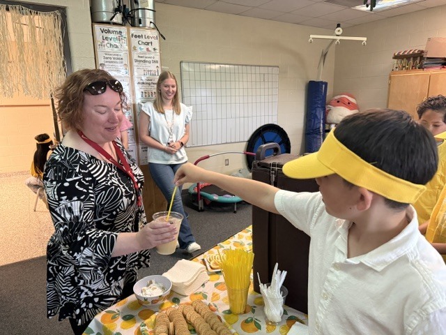 student serving lemondade