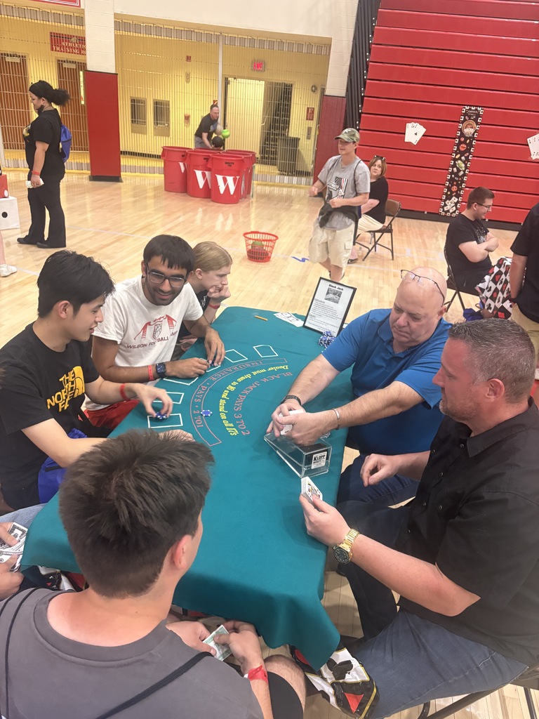 students playing card game at table