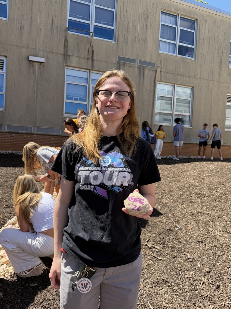 student holding rock they painted