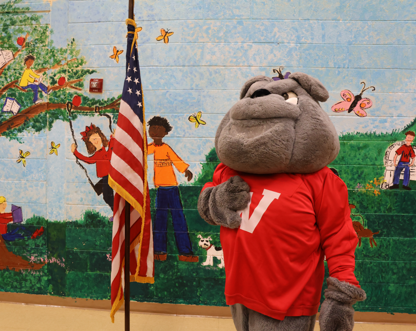 bulldog mascort next to american flag