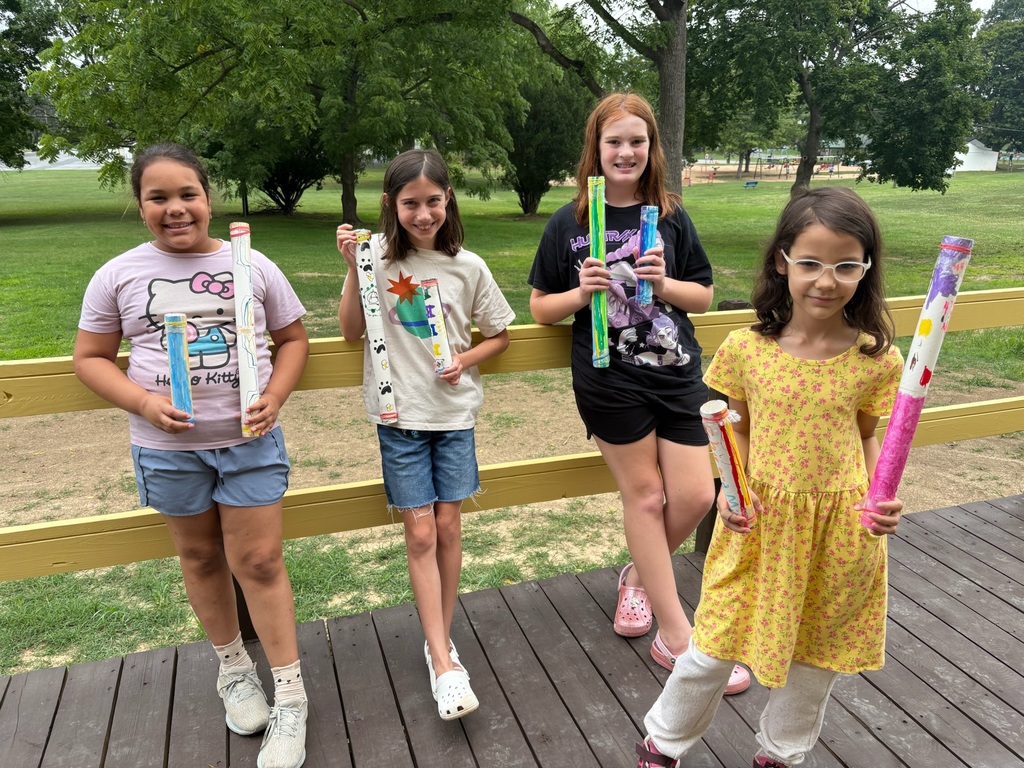studnets with decorated rain sticks
