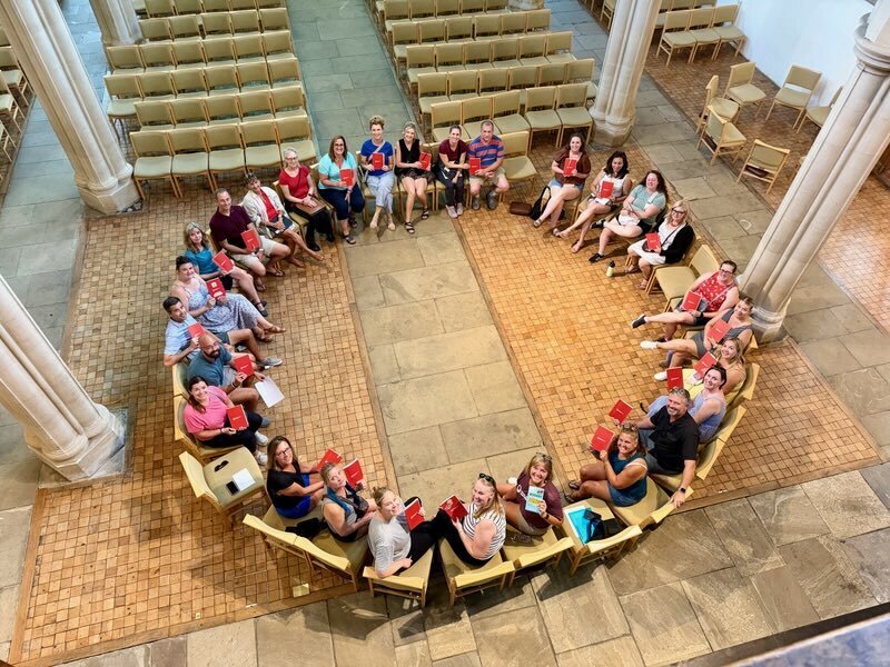 Group of educators sitting in a circle - photo taken from above