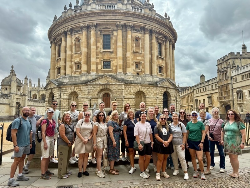 Group of educators standing outside brick building in oxford 