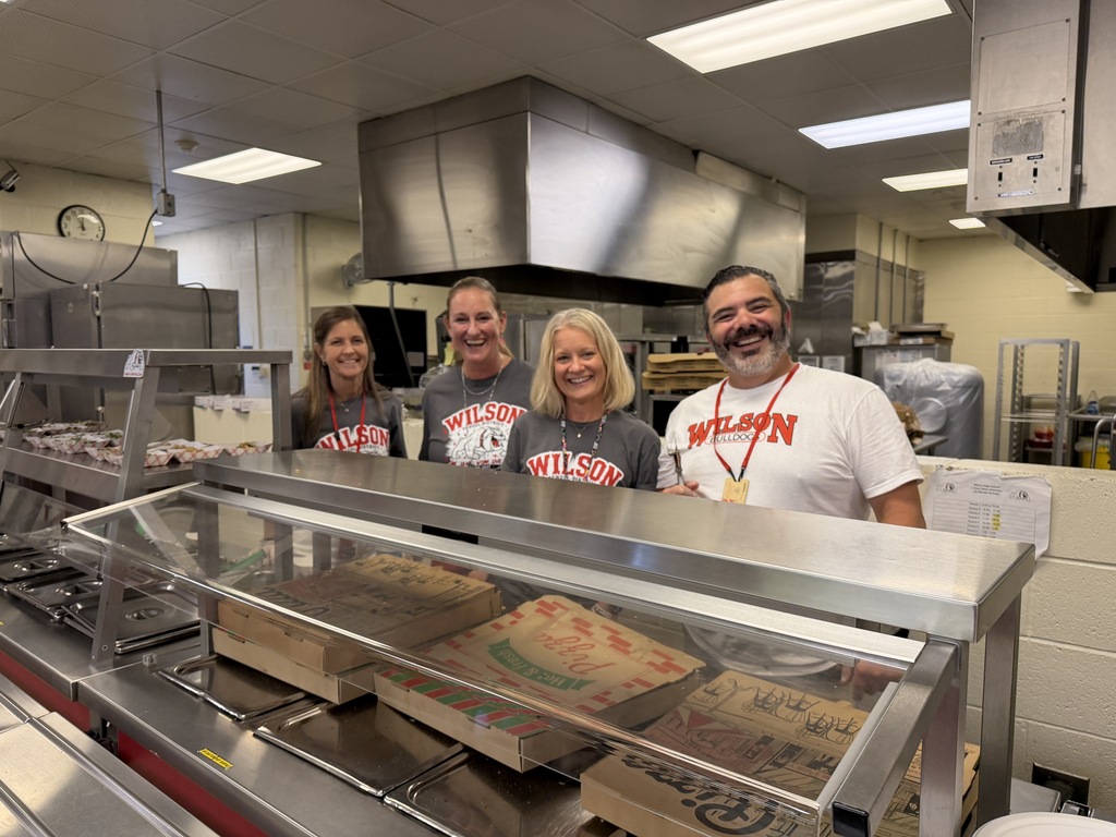staff members behind the counter serving food