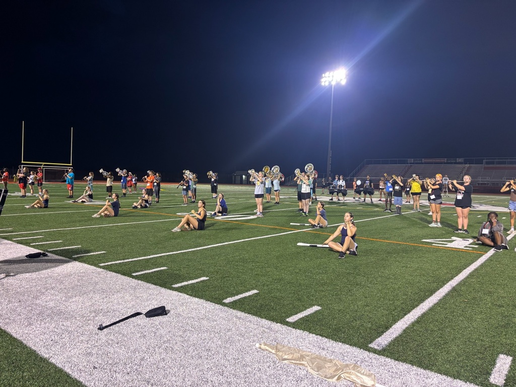 students playing on the field at night