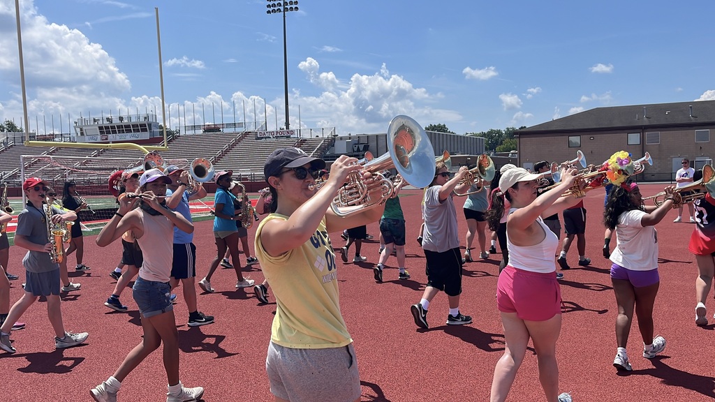 Marching band students playing their instruments
