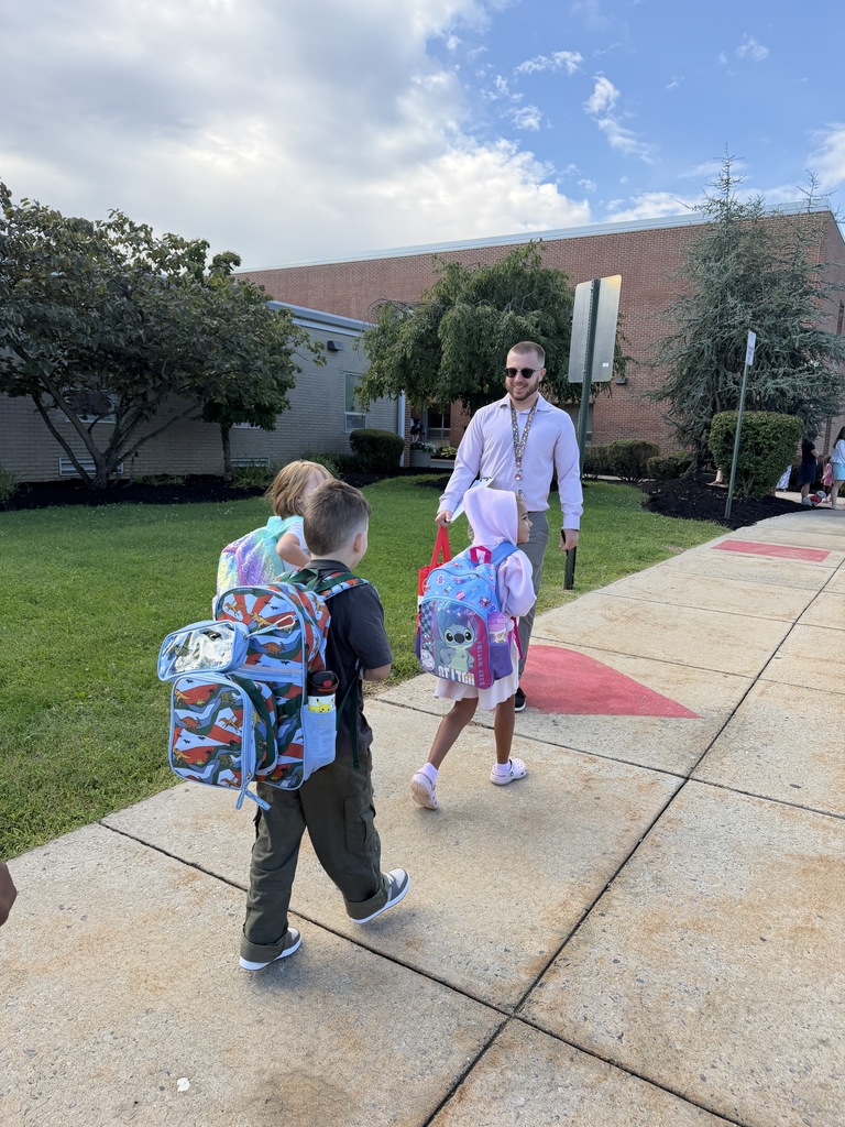students walking into building with their teacher