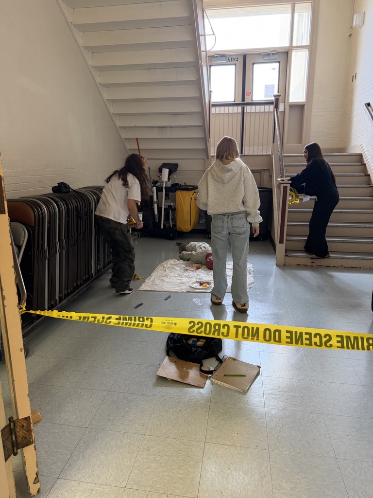 crime scene and three girls standing around her