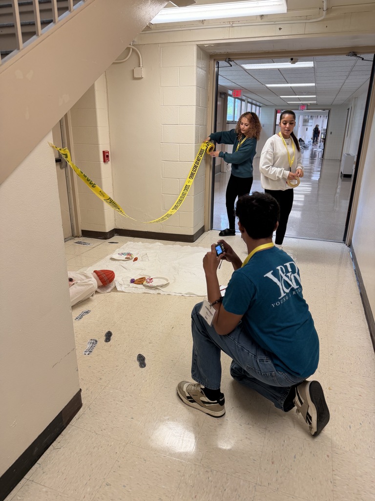 person taking pictures of fake crime scene