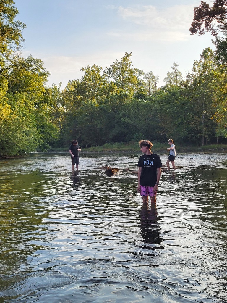 students standing in creek